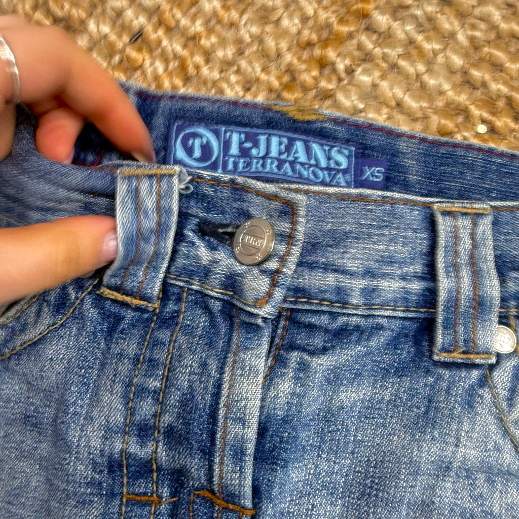 Blue denim low waisted distressed mini skirt
