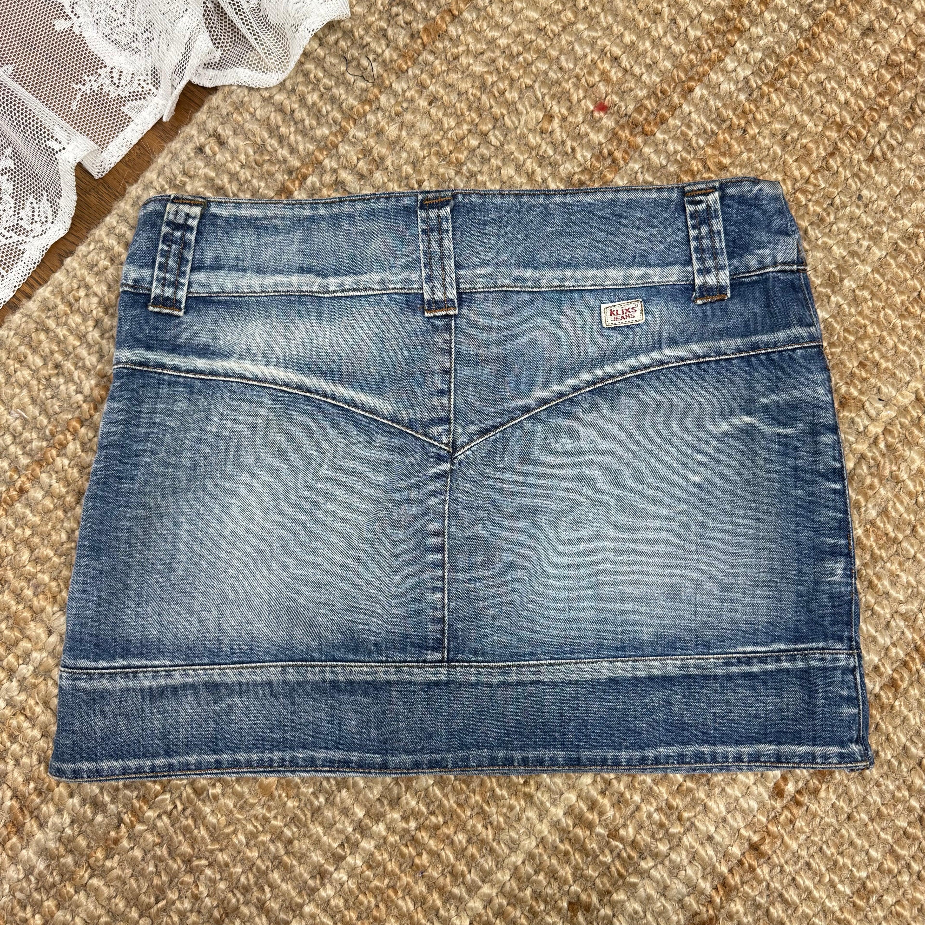 Blue washed denim mini skirt with button and zip detailing