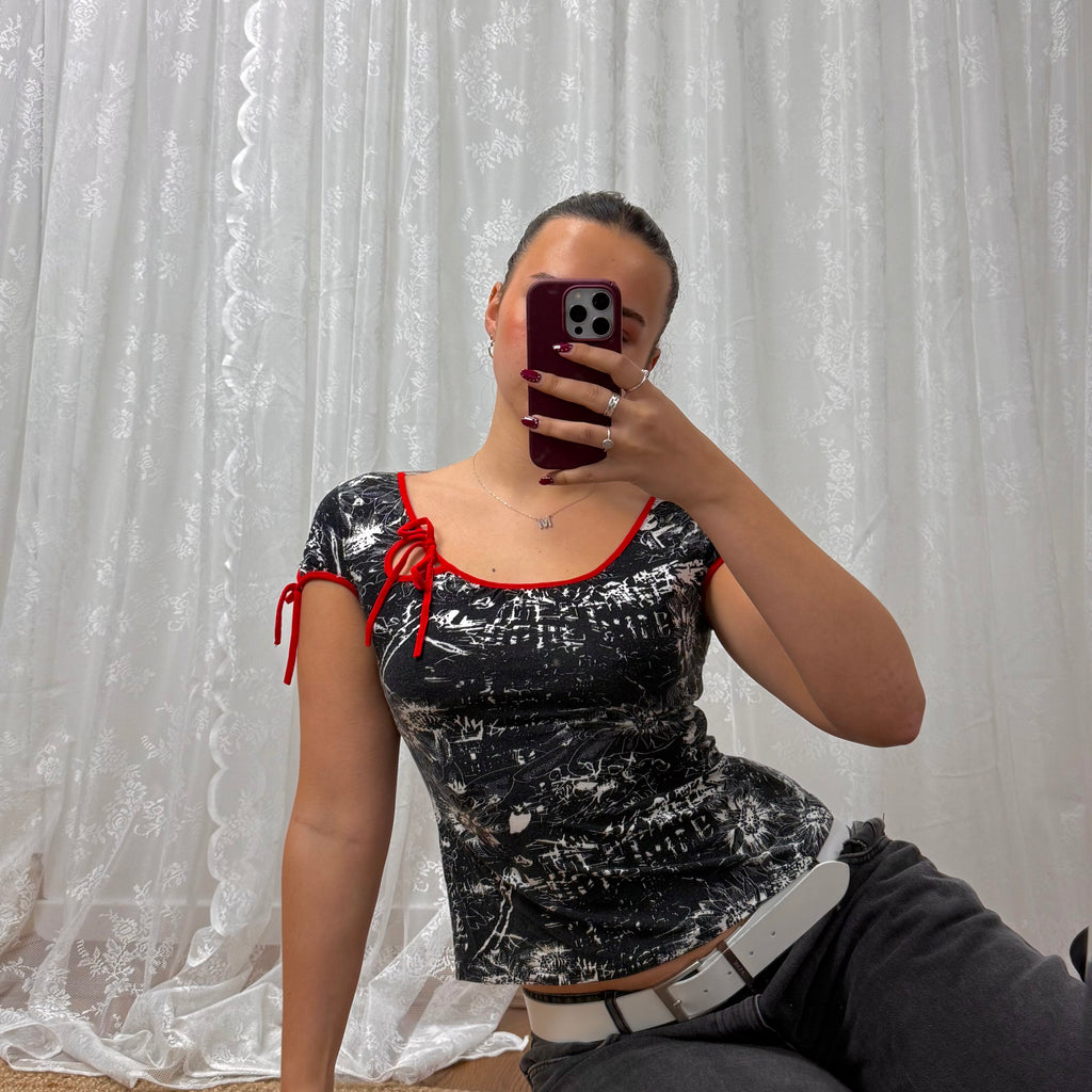 Black and white patterned top with red detailing