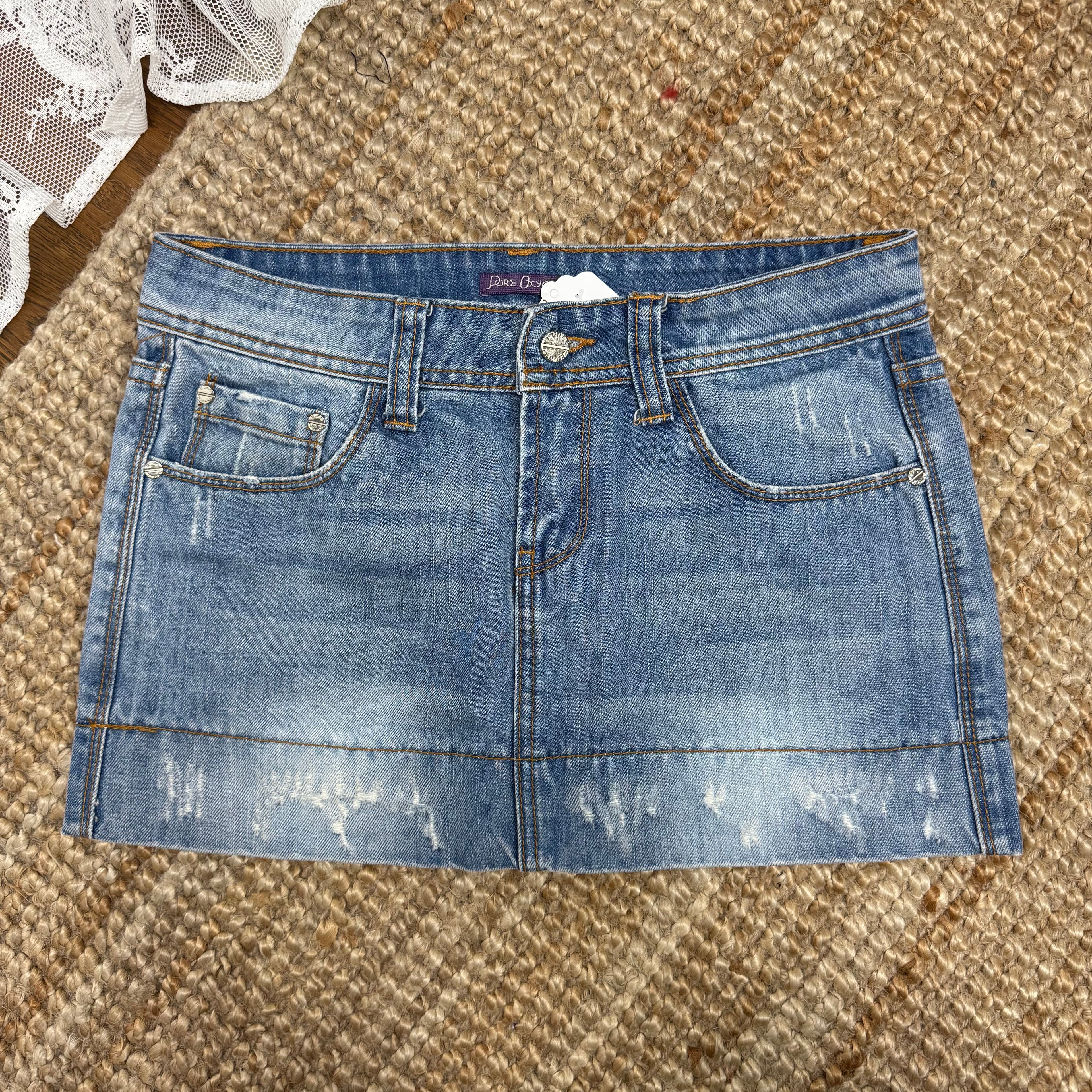 Light blue denim mini skirt with distressed detailing
