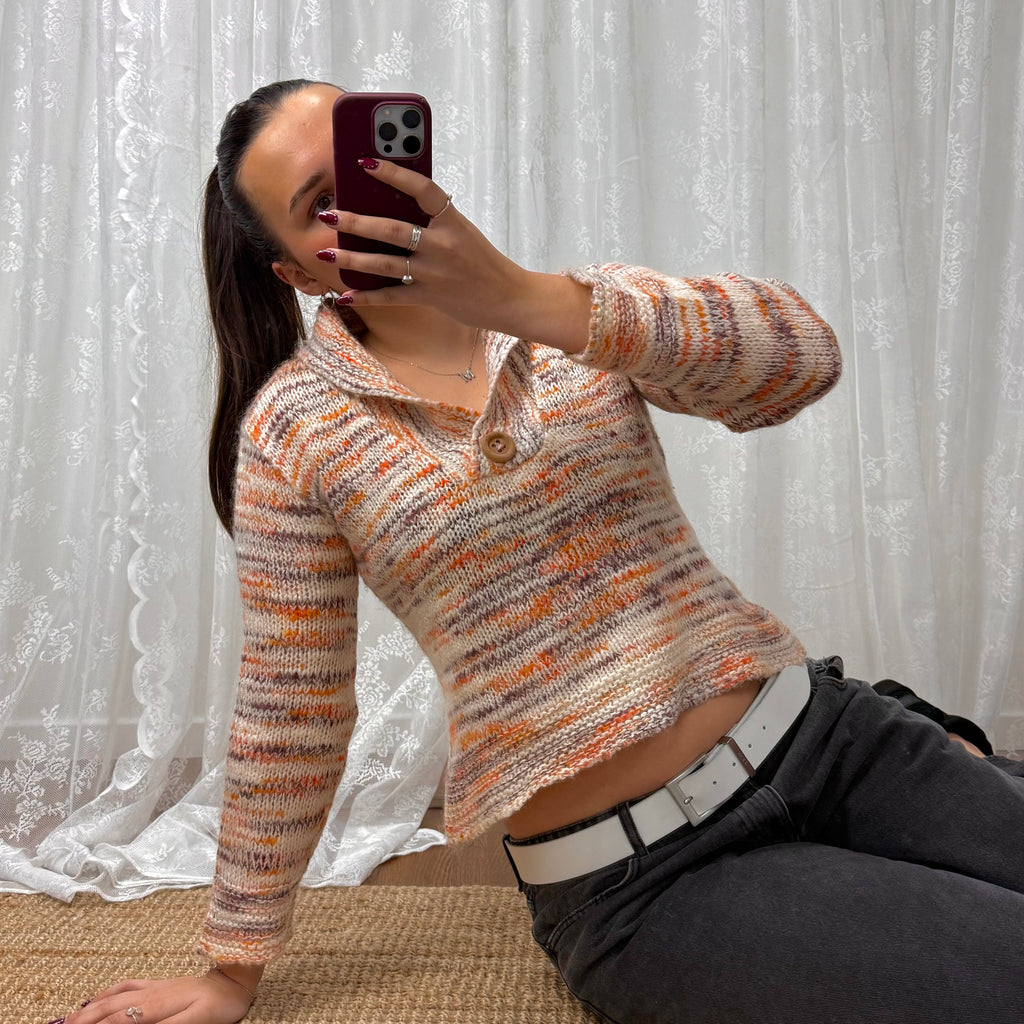 Orange and white patterned knit sweater with button up collar detail