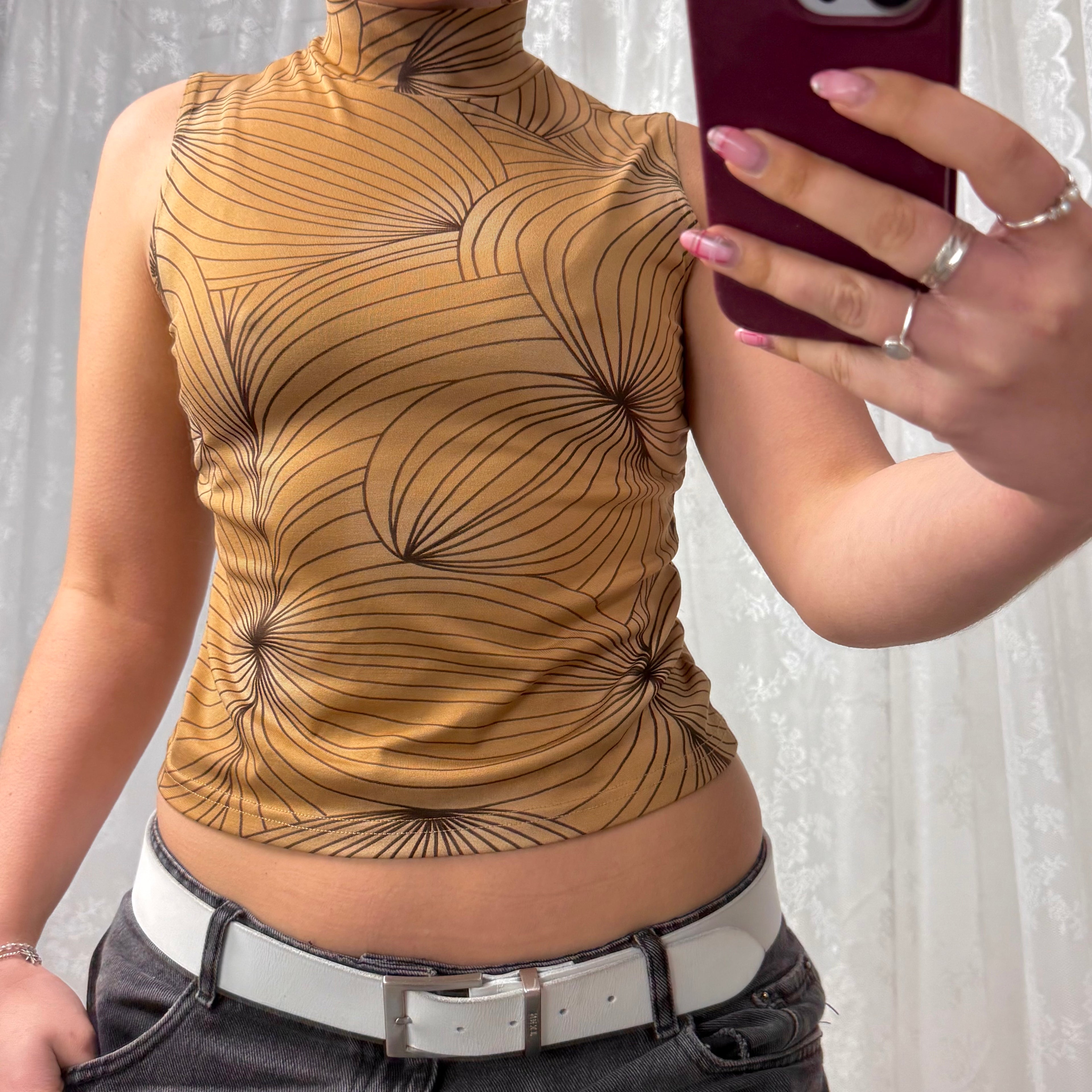 Beige patterned sleeveless turtleneck top