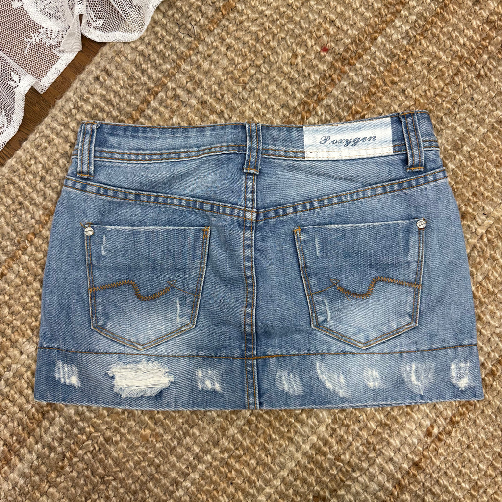 Light blue denim mini skirt with distressed detailing