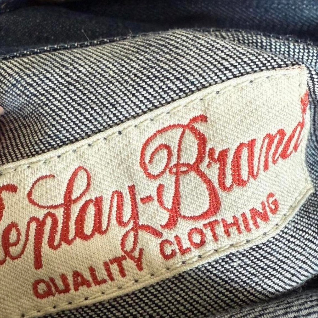 Dark denim fitted jacket with pleated detailing and silver buttons