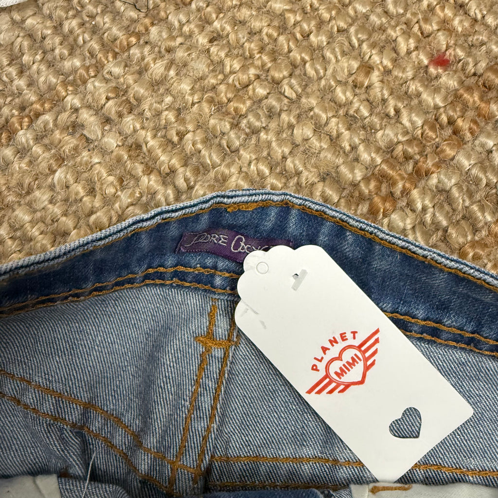 Light blue denim mini skirt with distressed detailing