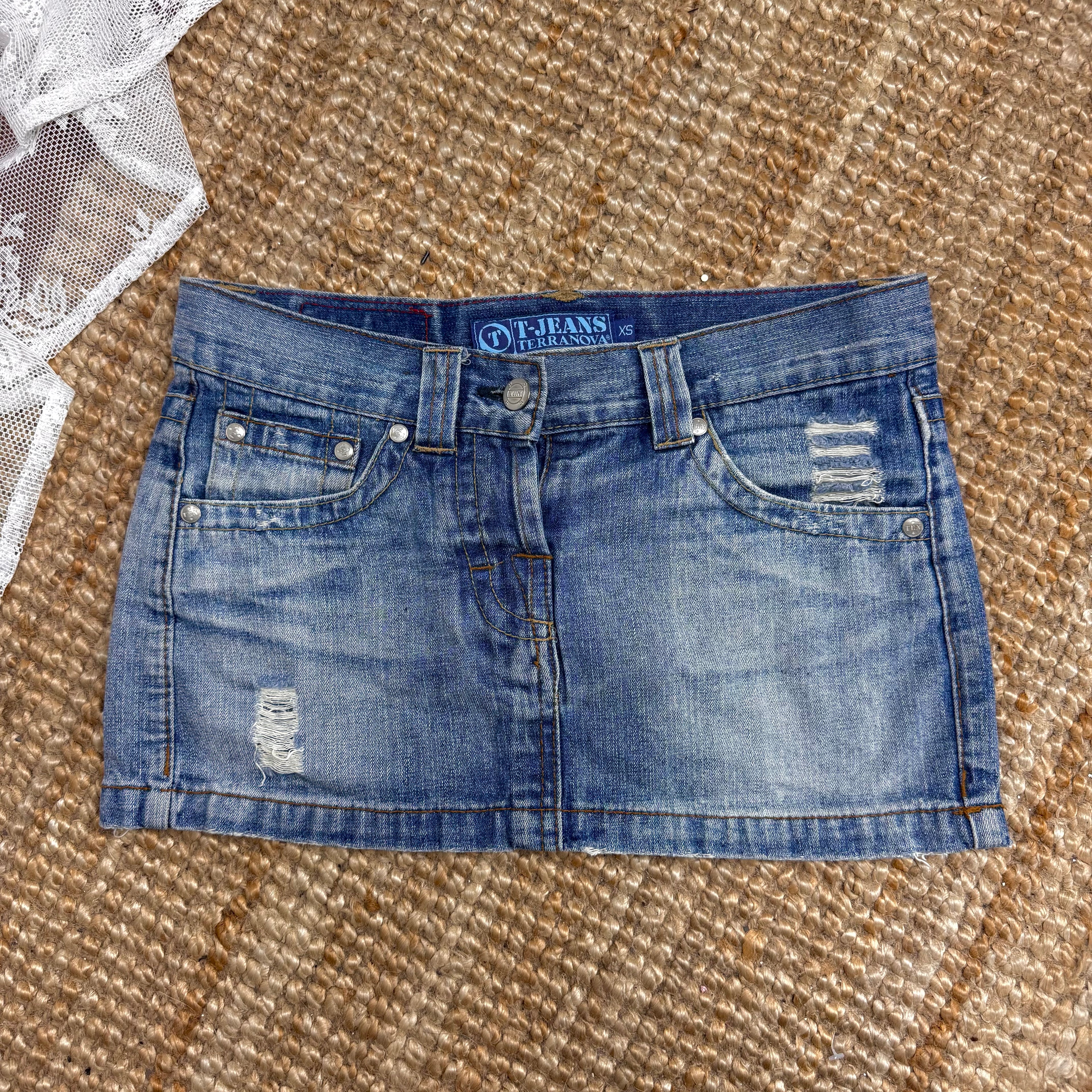 Blue denim low waisted distressed mini skirt