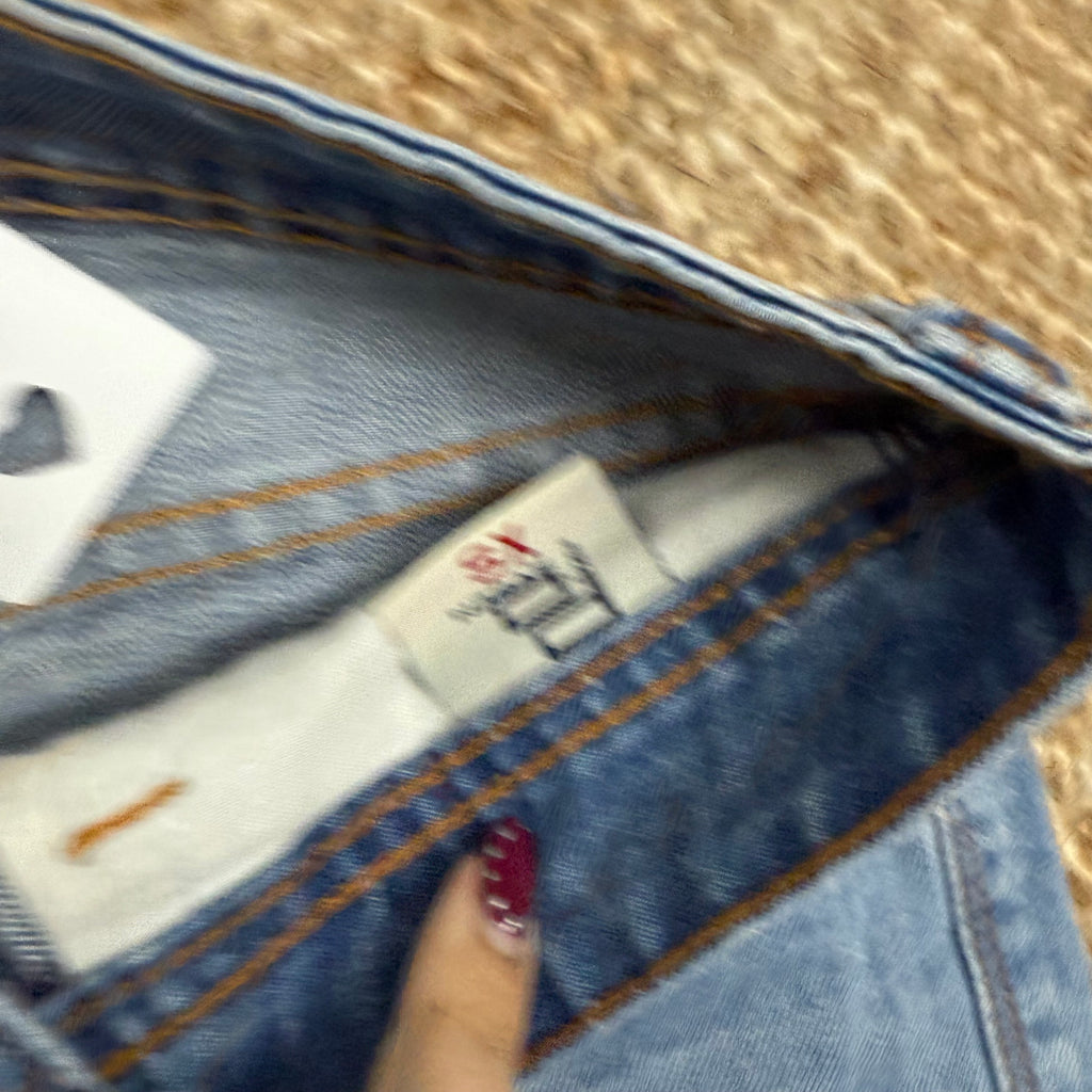 Light blue denim mini skirt with distressed detailing