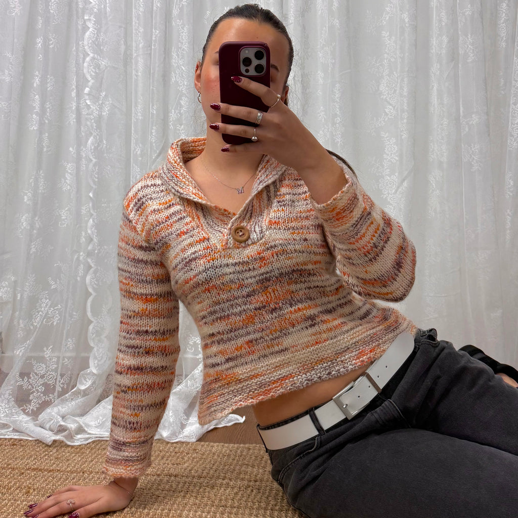 Orange and white patterned knit sweater with button up collar detail