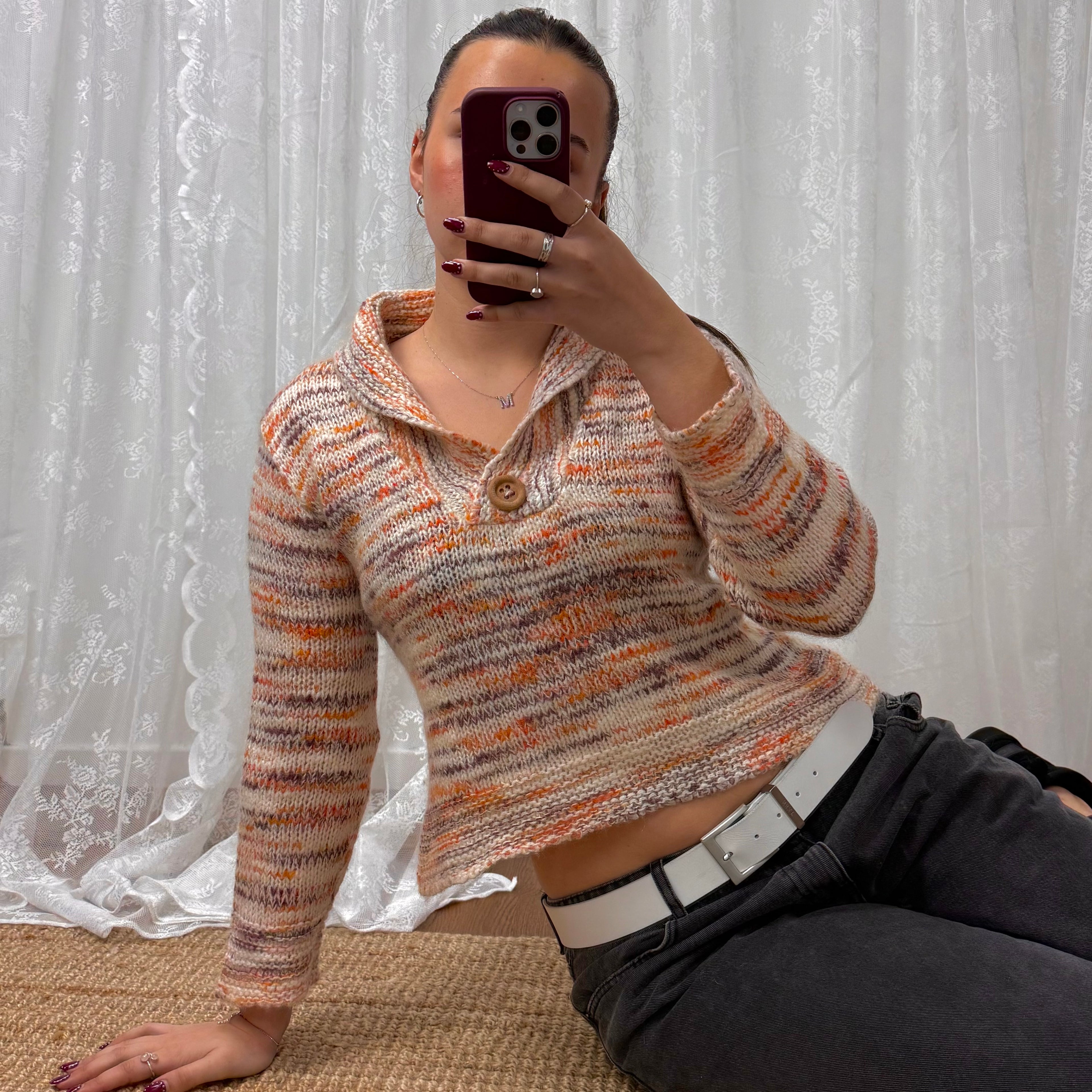 Orange and white patterned knit sweater with button up collar detail