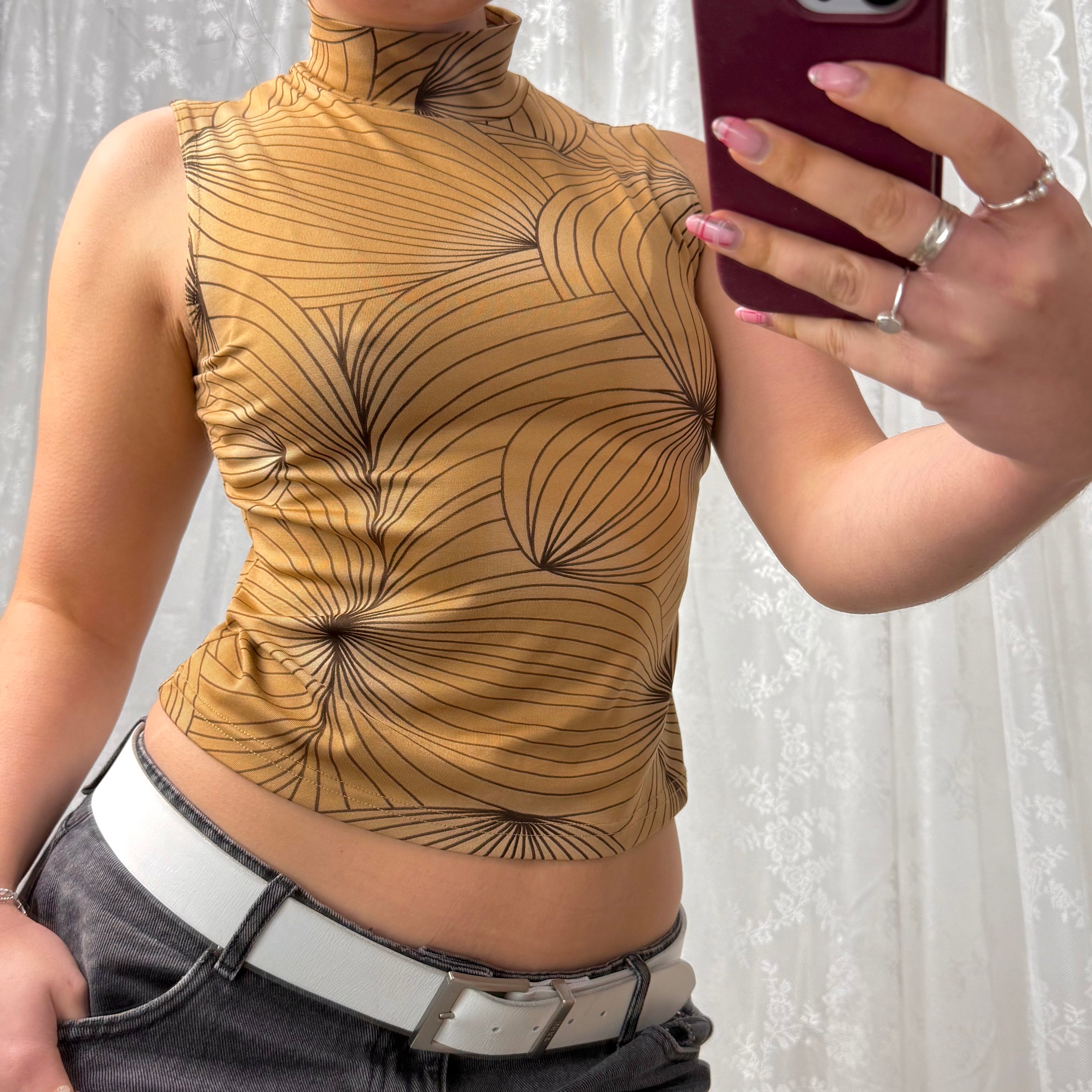 Beige patterned sleeveless turtleneck top