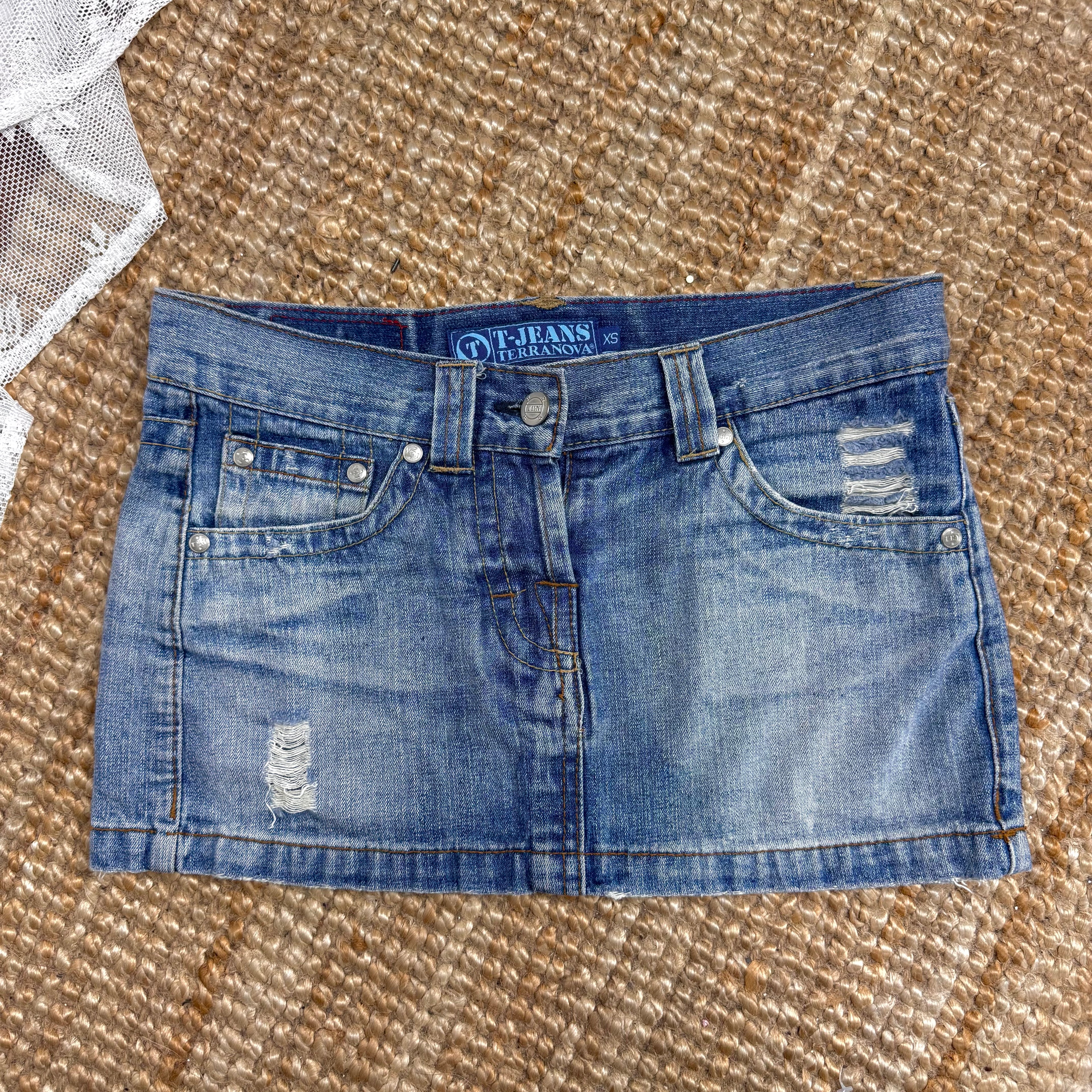 Blue denim low waisted distressed mini skirt