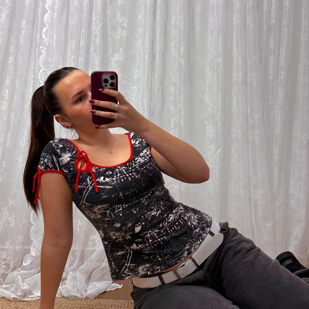 Black and white patterned top with red detailing