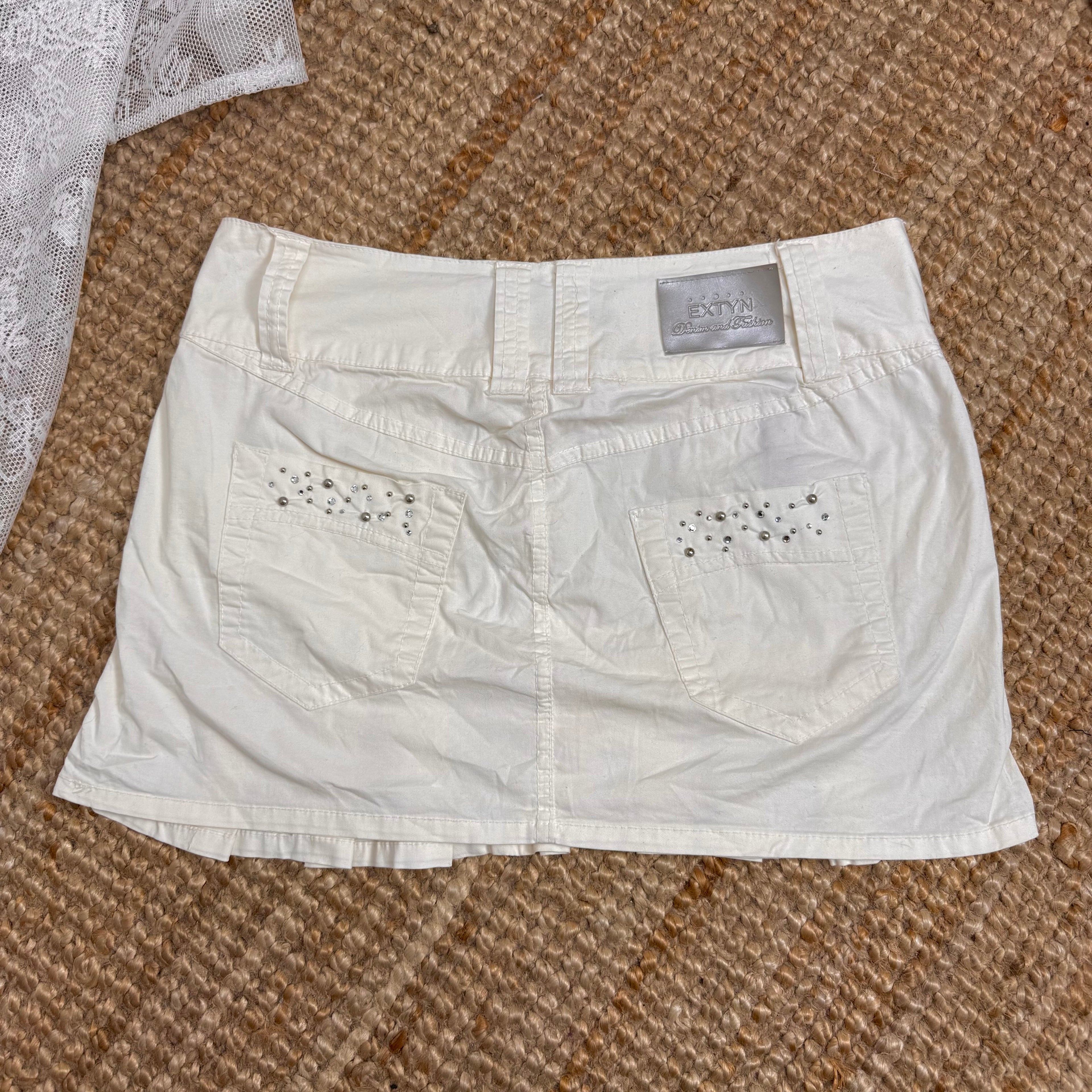 White pleated gel low waisted mini skirt
