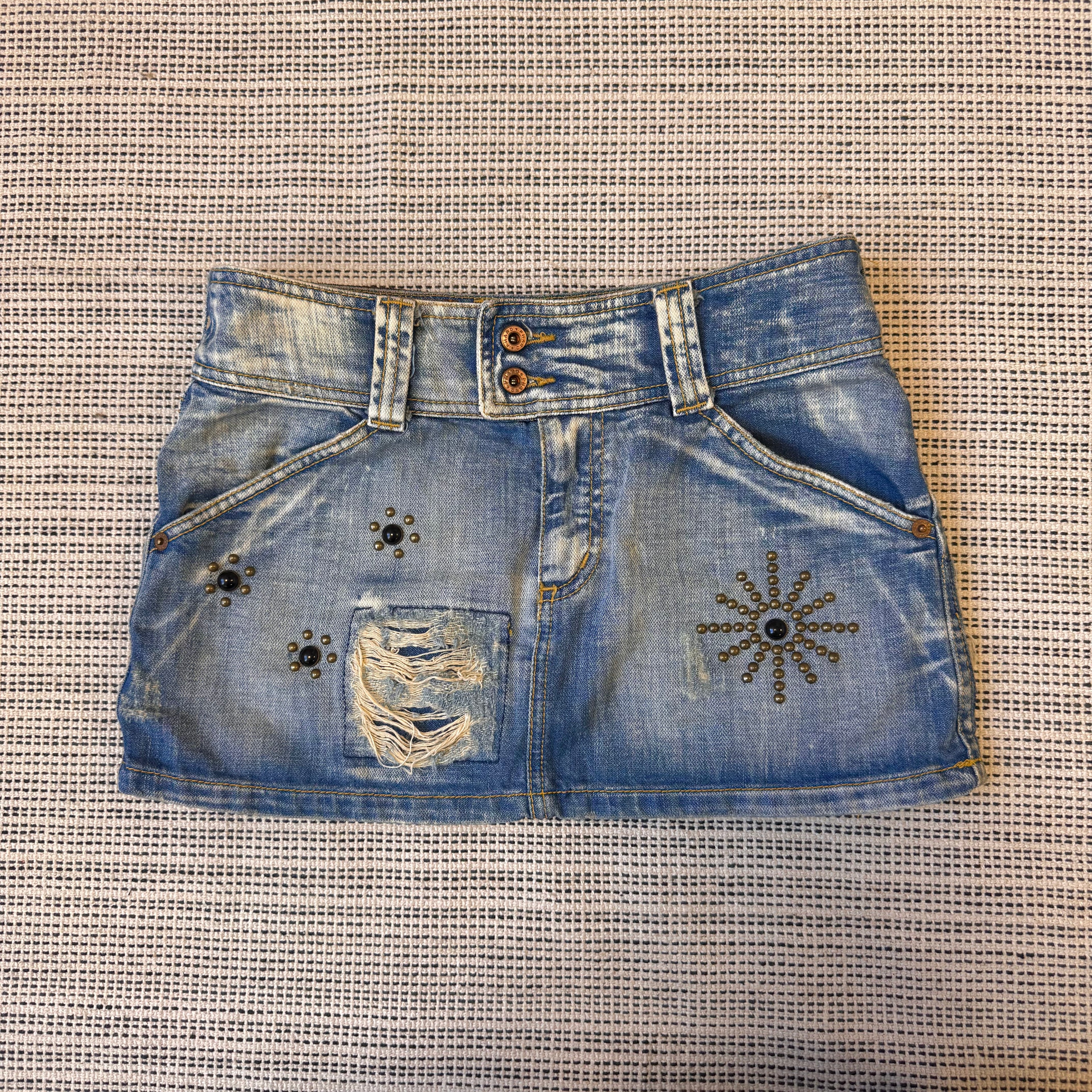 Blue denim distressed stuffed mini skirt