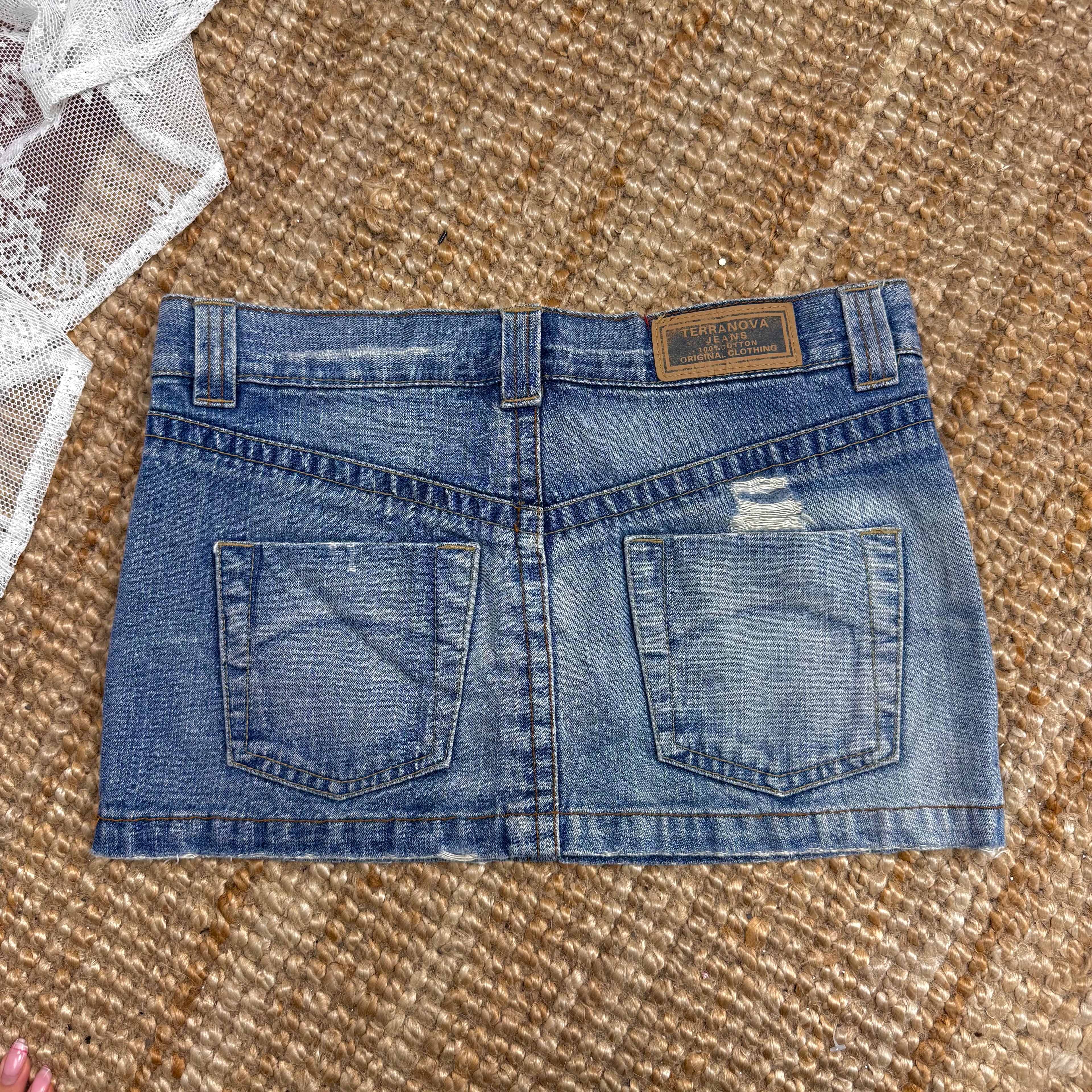 Blue denim low waisted distressed mini skirt
