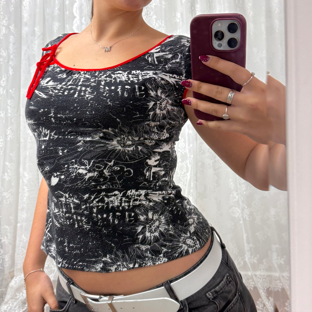 Black and white patterned top with red detailing