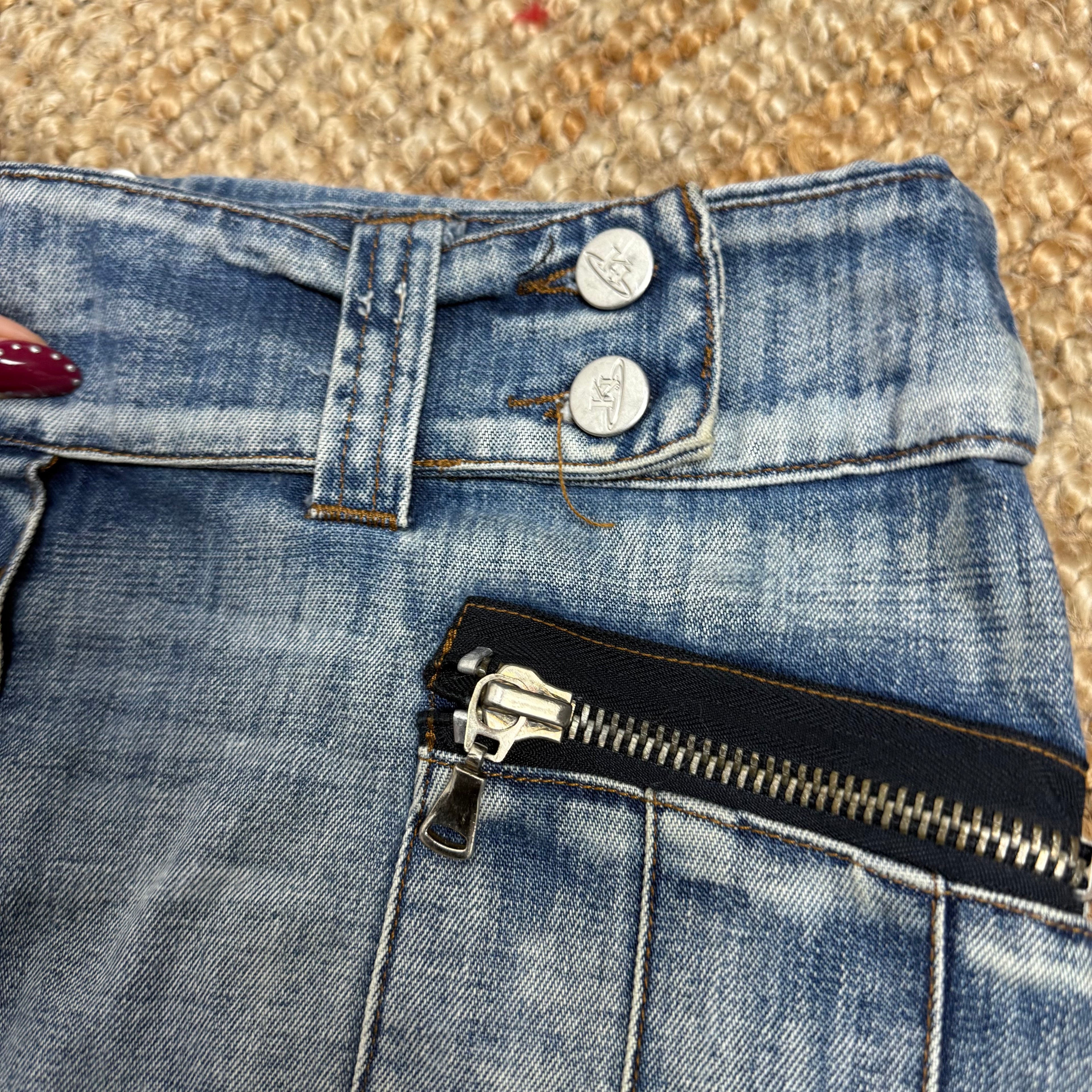 Blue washed denim mini skirt with button and zip detailing