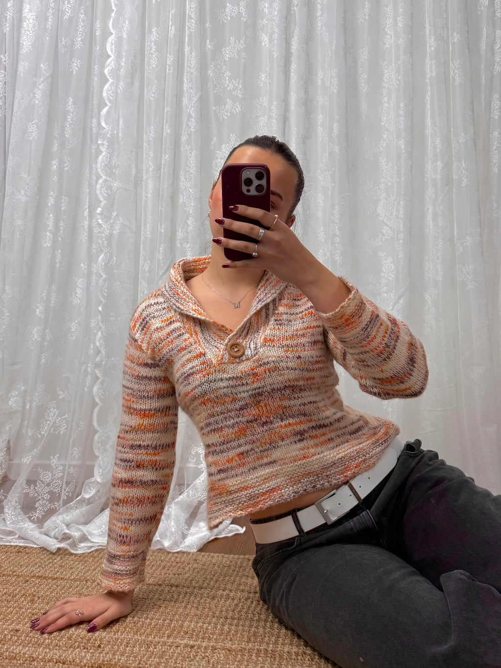 Orange and white patterned knit sweater with button up collar detail