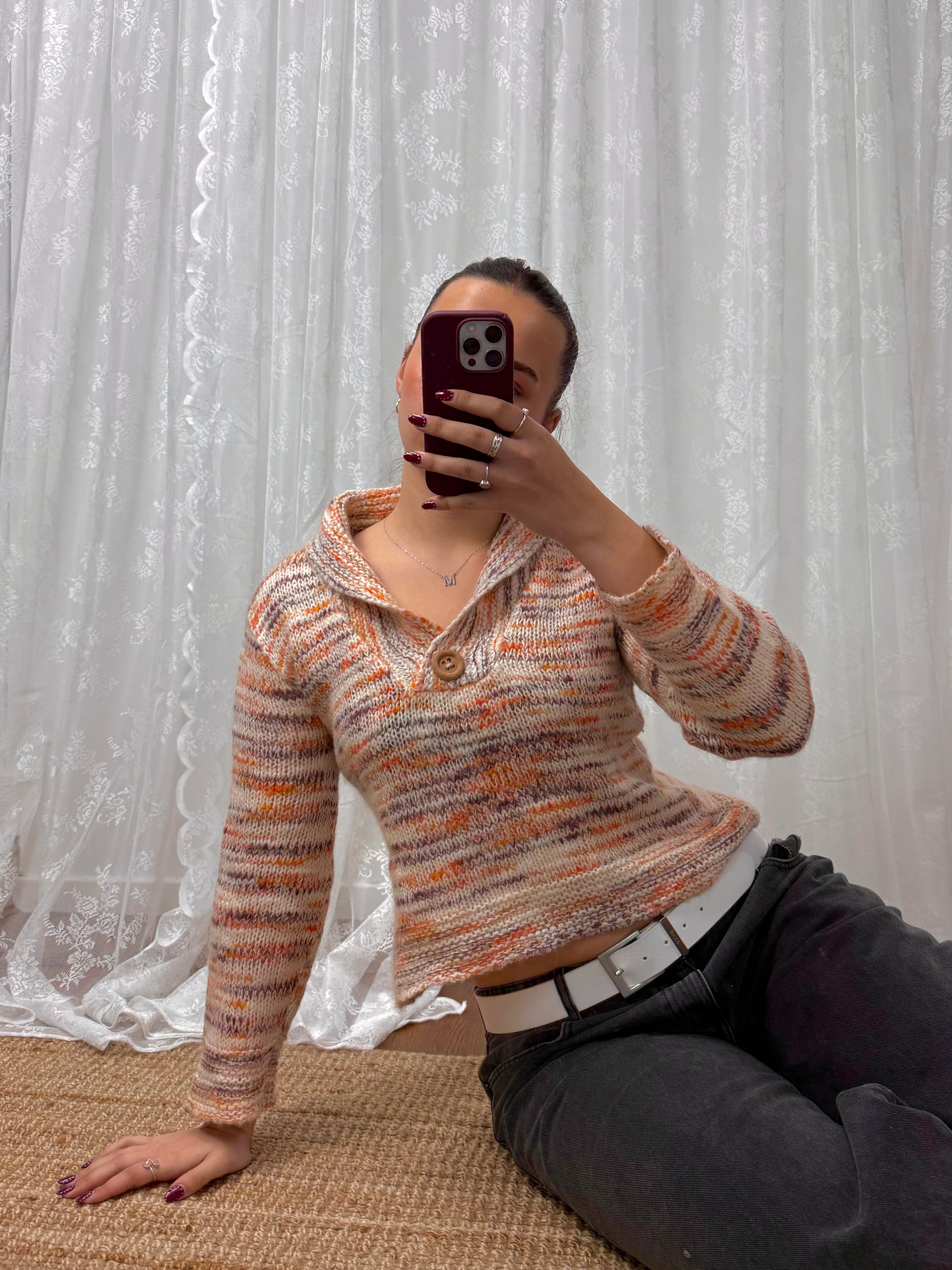 Orange and white patterned knit sweater with button up collar detail