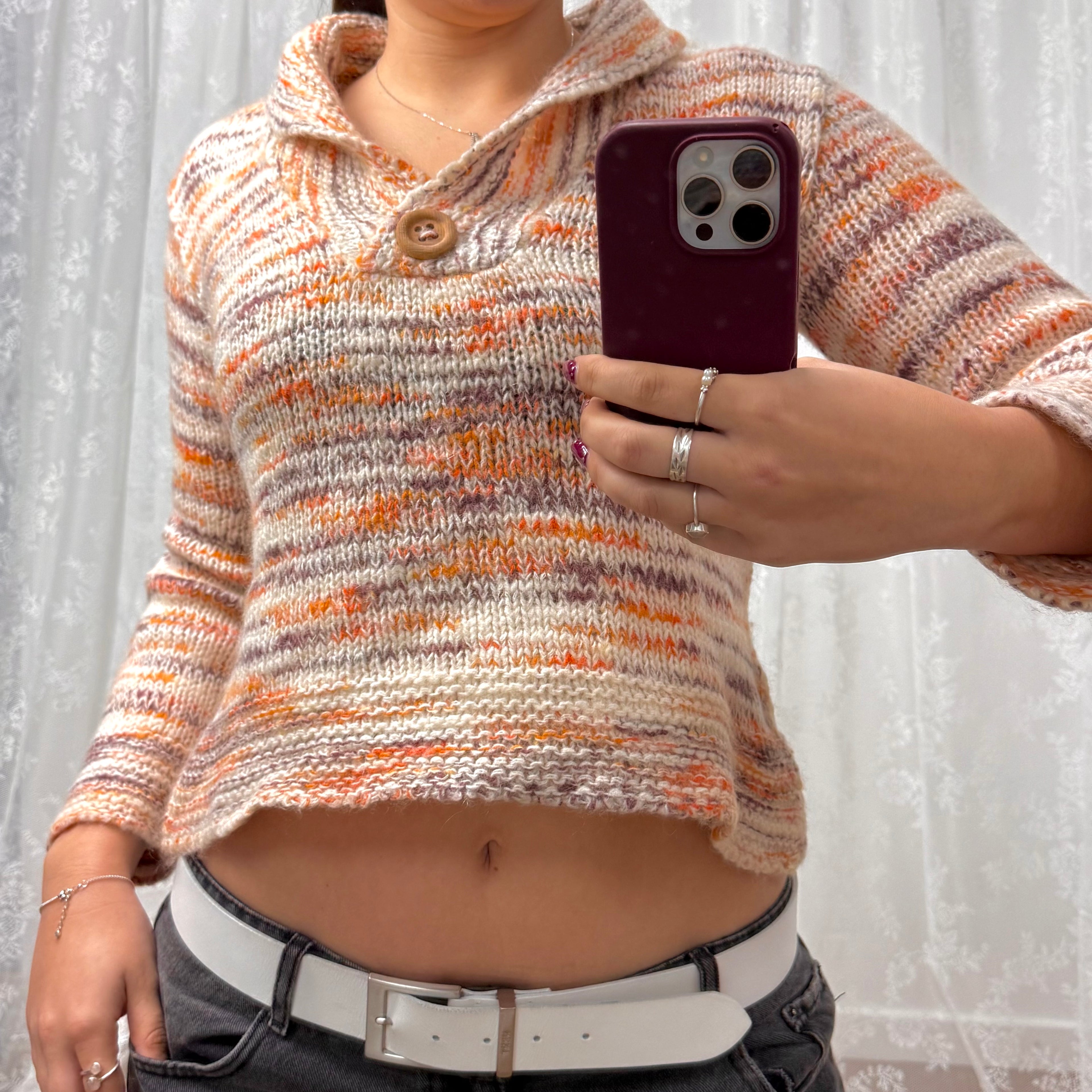 Orange and white patterned knit sweater with button up collar detail