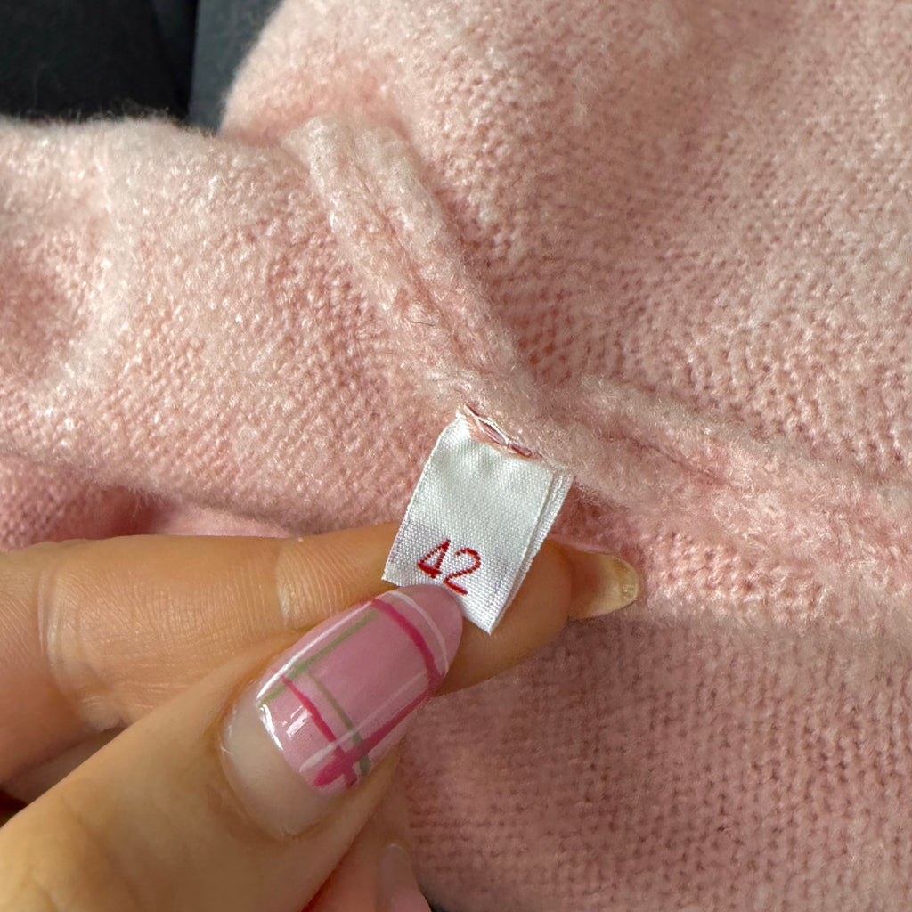 Pink sweater with faux fur trim and bow detailing