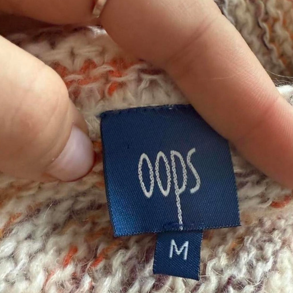 Orange and white patterned knit sweater with button up collar detail